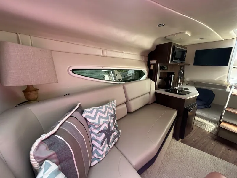 Slide: The Image of 2017 Regal 26 Express cabin interior with sofa, pillows, kitchenette, and modern amenities. - 39