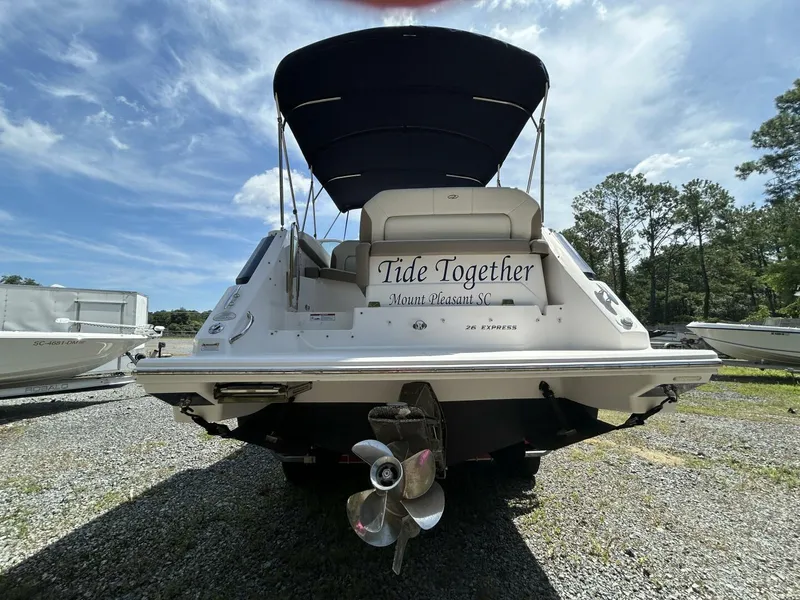 Slide: The Image of 2017 Regal 26 Express boat named "Tide Together" with canopy, parked outdoors. - 4