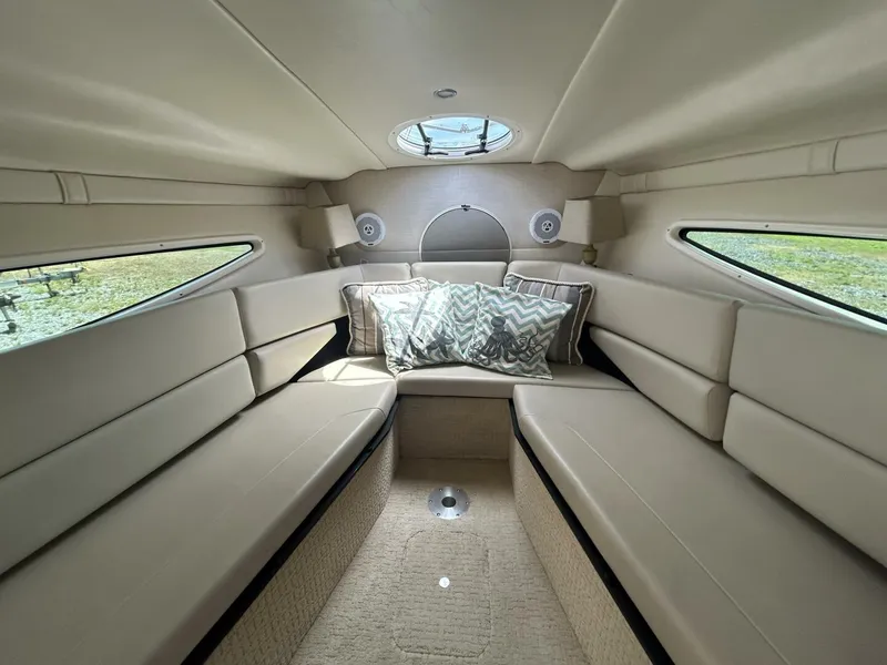 Slide: The Image of 2017 Regal 26 Express cabin interior with beige seating and decorative pillows. - 40