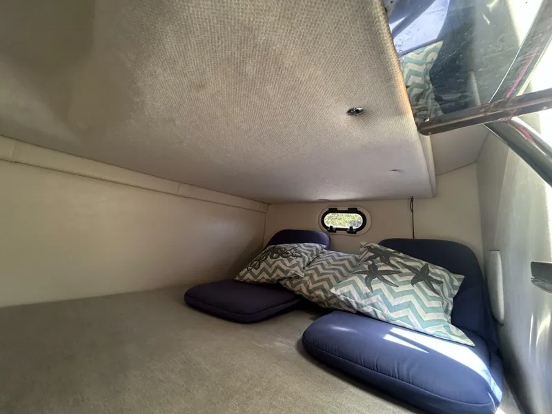 Slide: The Image of Cozy cabin interior of 2017 Regal 26 Express boat with cushions and pillows. - 44