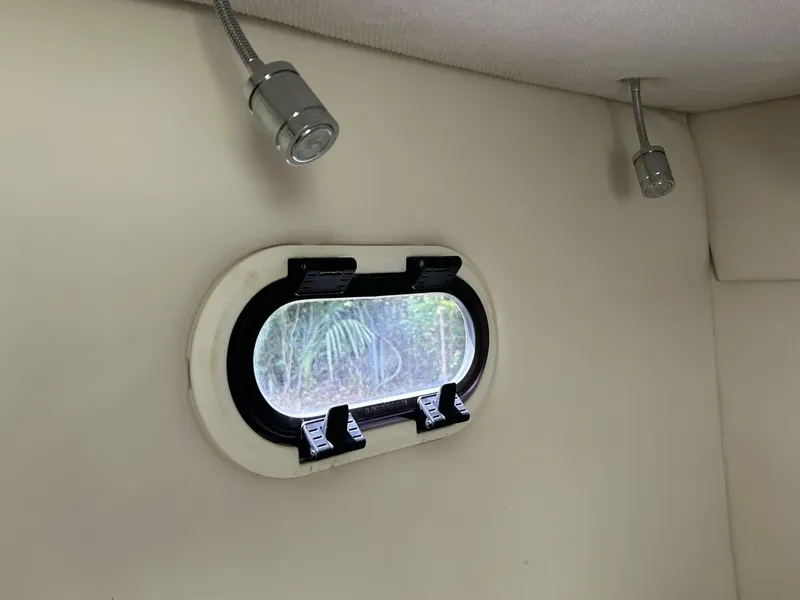 Slide: The Image of Interior of 2017 Regal 26 Express boat with porthole and ceiling lights. - 46