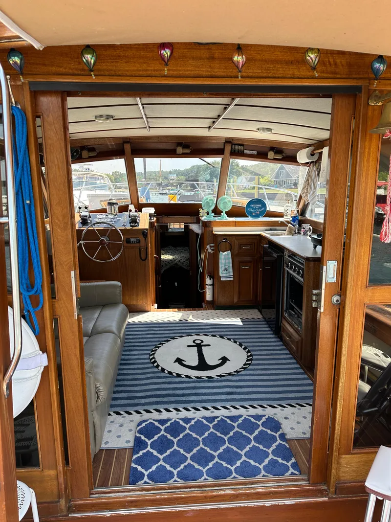 Slide: The Image of Interior of a 1977 Egg Harbor 33 Sedan boat with nautical decor and wooden finishes. - 10