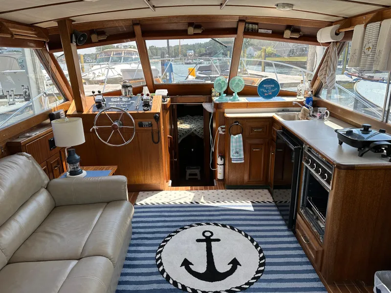 Slide: The Image of Interior of a 1977 Egg Harbor 33 Sedan boat with cozy seating and nautical decor. - 11