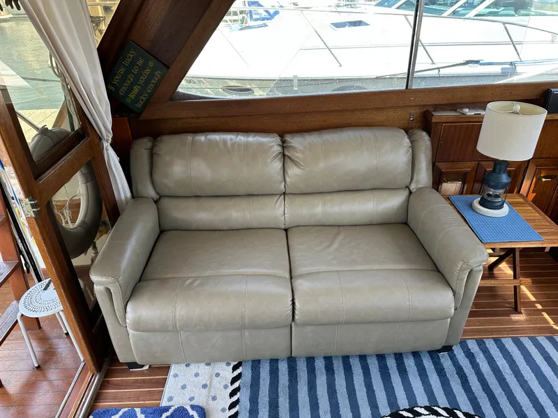 Slide: The Image of 1977 Egg Harbor 33 Sedan interior with beige leather sofa and nautical decor. - 12