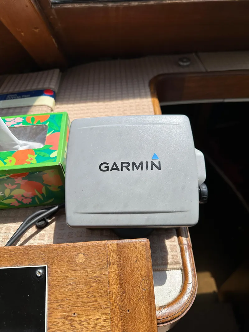 Slide: The Image of Garmin device on 1977 Egg Harbor 33 Sedan boat dashboard, next to floral tissue box. - 15