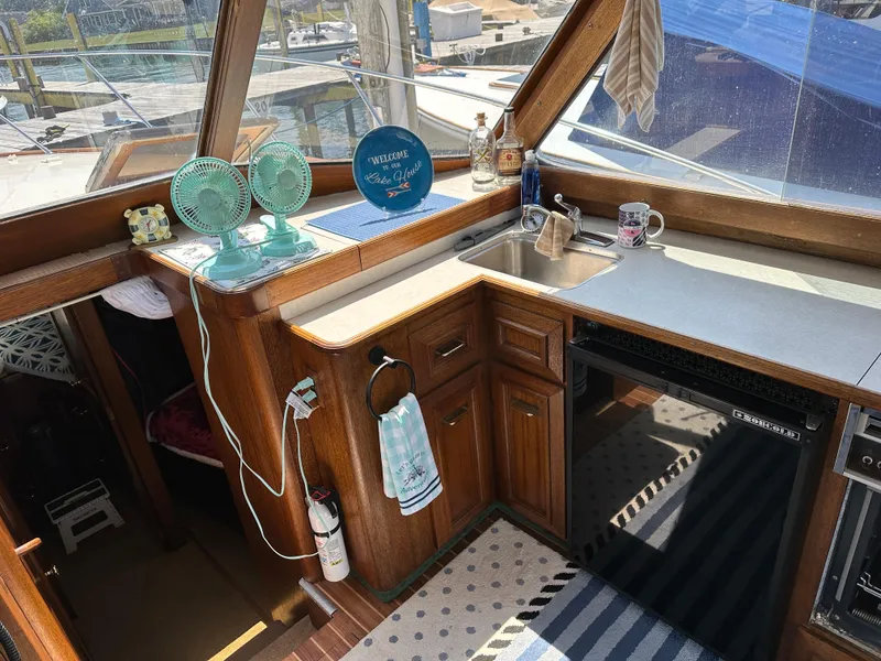 Slide: The Image of Interior of a 1977 Egg Harbor 33 Sedan boat with kitchen amenities. - 16