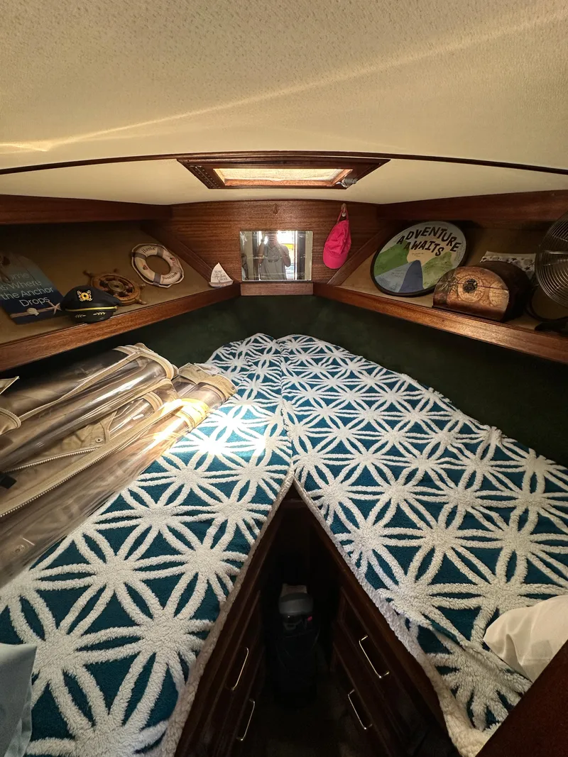 Slide: The Image of 1977 Egg Harbor 33 Sedan cabin interior with patterned bedding and nautical decor. - 19