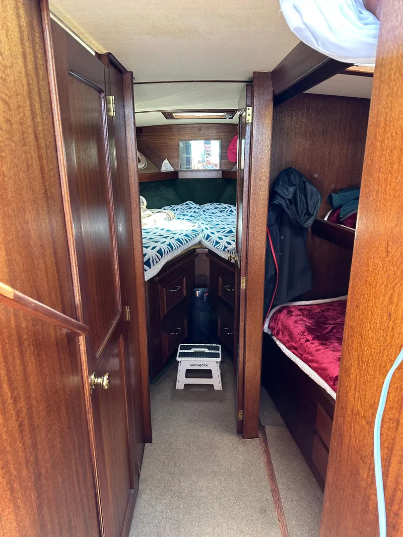 Slide: The Image of Interior of a 1977 Egg Harbor 33 Sedan boat with wooden cabinetry and cozy sleeping area. - 20
