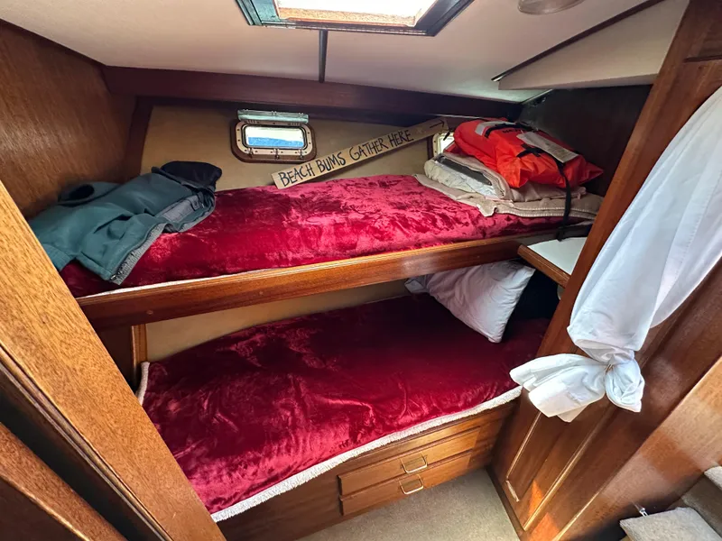 Slide: The Image of 1977 Egg Harbor 33 Sedan cabin with cozy bunk beds and nautical decor. - 21