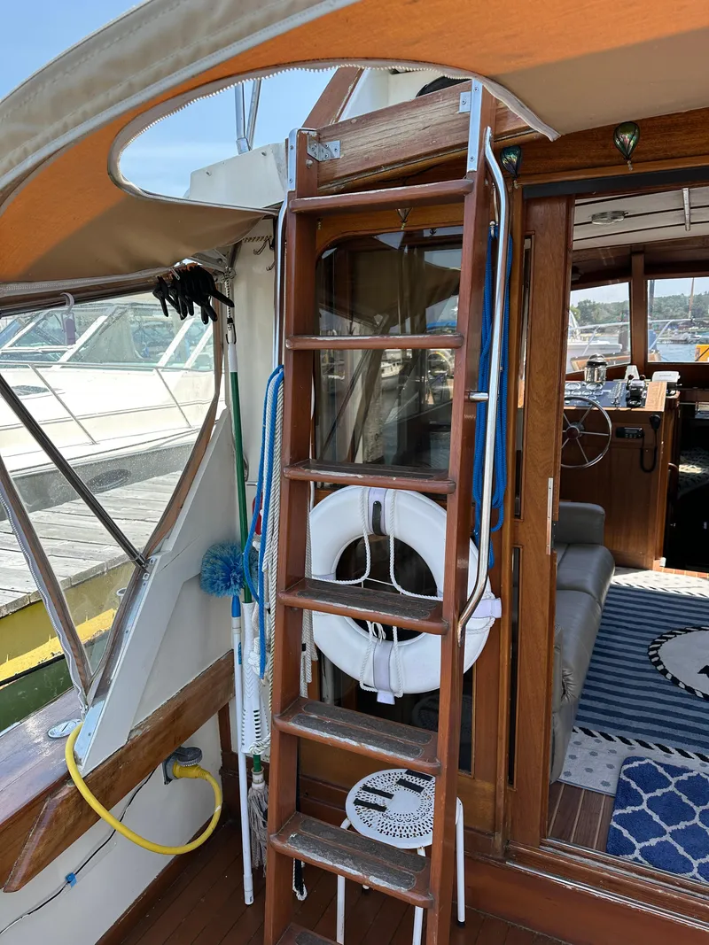 Slide: The Image of 1977 Egg Harbor 33 Sedan boat interior with wooden ladder and life preserver. - 29