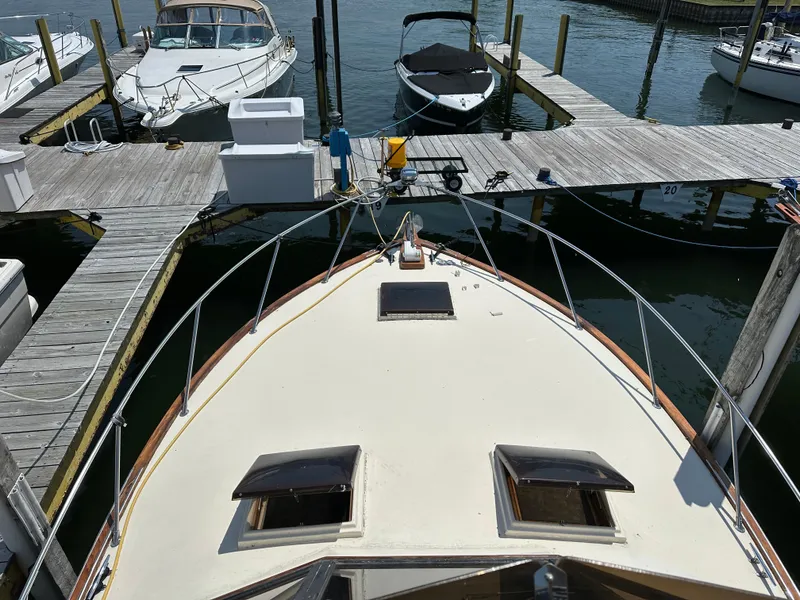 Slide: The Image of 1977 Egg Harbor 33 Sedan docked at marina with other boats. - 30