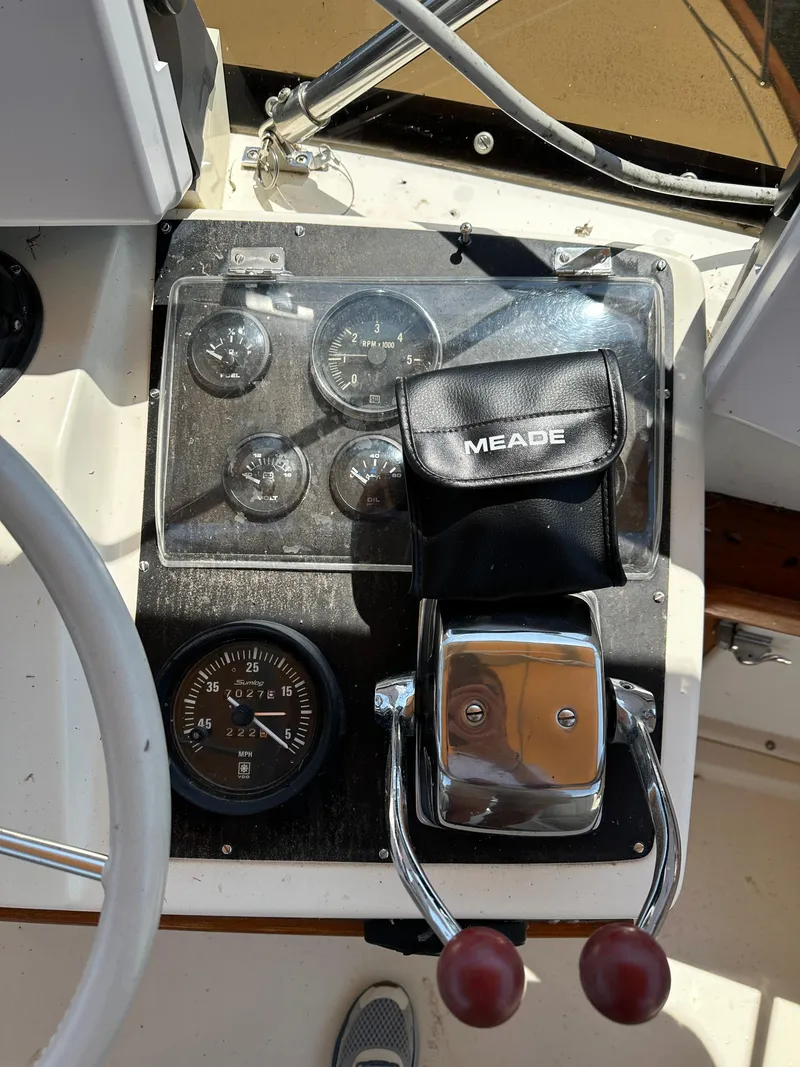 Slide: The Image of 1977 Egg Harbor 33 Sedan boat dashboard with gauges and controls. - 32
