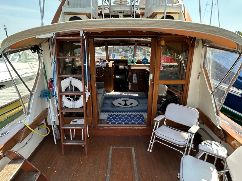 Slide: The Image of 1977 Egg Harbor 33 Sedan boat interior with wooden deck and nautical decor. - 9
