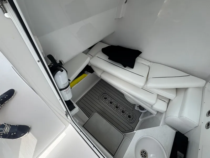 Slide: The Image of 2024 Sportsman Open 302 Center Console interior with seating and fire extinguisher. - 10