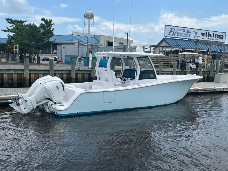 Slide: The Image of 2024 Sportsman Open 302 Center Console boat docked at marina. - 3