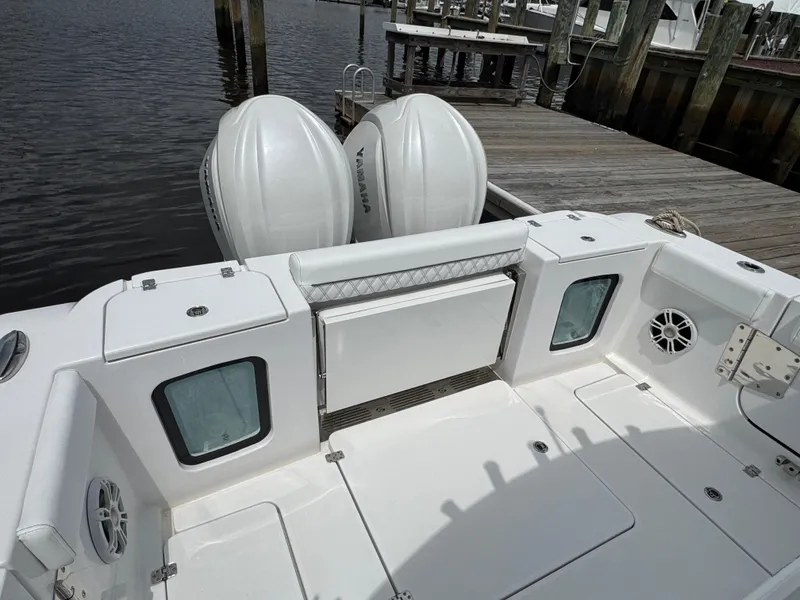 Slide: The Image of 2024 Sportsman Open 302 Center Console boat docked, featuring dual Yamaha engines. - 7