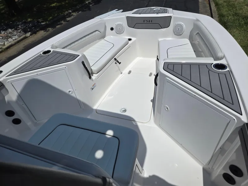 Slide: The Image of 2018 Yamaha Boats 210 FSH Sport interior with seating and storage compartments. - 12