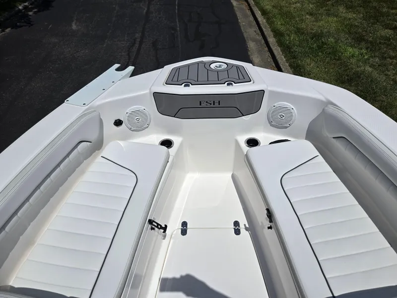 Slide: The Image of 2018 Yamaha Boats 210 FSH Sport interior with white seating and speakers. - 15