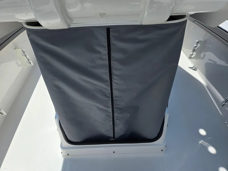 Slide: The Image of 2018 Yamaha Boats 210 FSH Sport interior with gray storage cover. - 18