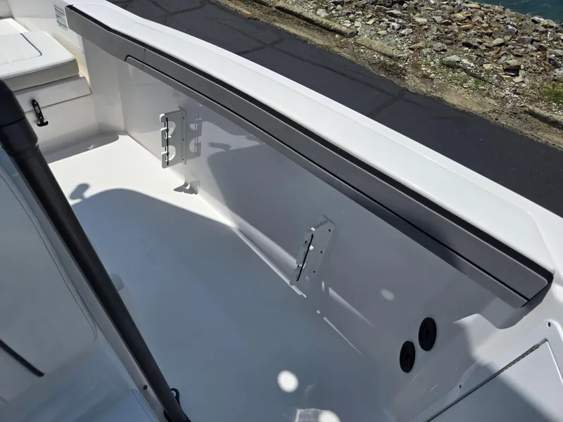 Slide: The Image of 2018 Yamaha Boats 210 FSH Sport interior detail with seating and storage. - 19