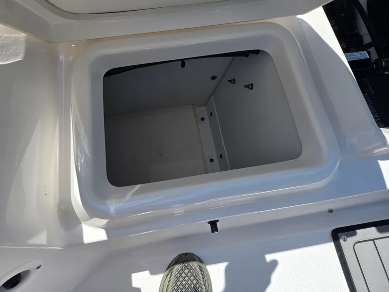 Slide: The Image of Open storage compartment on 2018 Yamaha Boats 210 FSH Sport. - 23