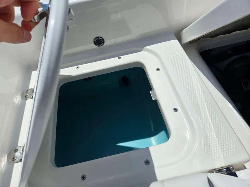 Slide: The Image of Open storage compartment on 2018 Yamaha Boats 210 FSH Sport, showing interior details. - 24