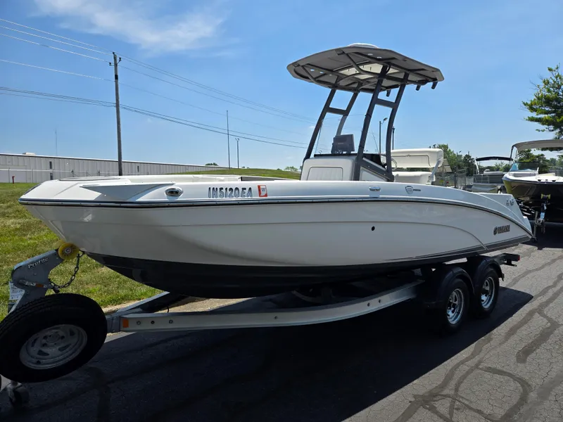 Slide: The Image of 2018 Yamaha Boats 210 FSH Sport on trailer, parked outdoors under clear sky. - 5