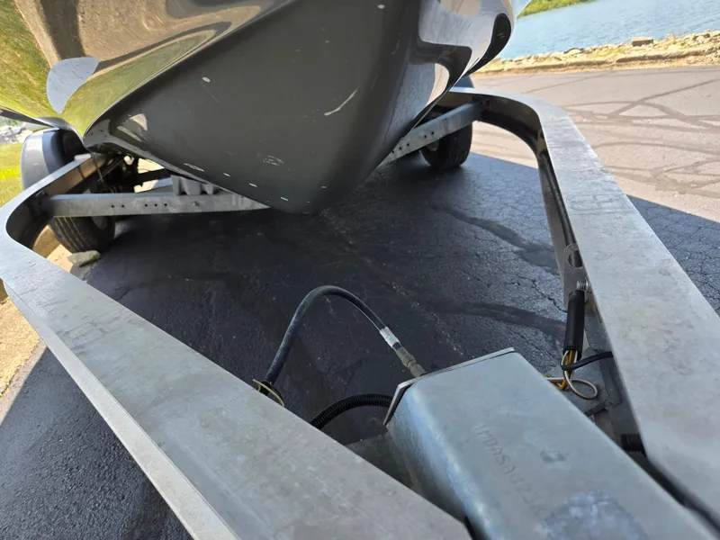 Slide: The Image of 2018 Yamaha Boats 210 FSH Sport on trailer near water. - 7