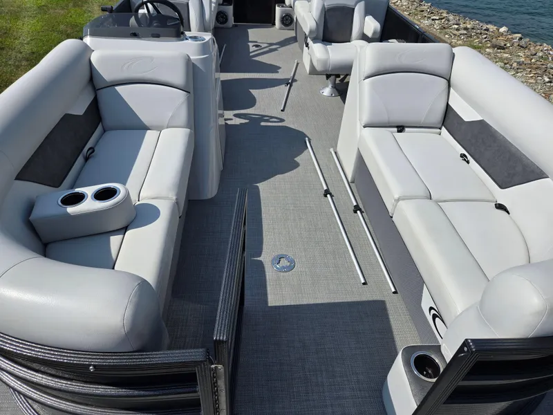 Slide: The Image of 2021 Crest Classic LX 220 SLC pontoon boat interior with plush seating and cup holders. - 11