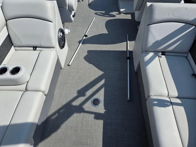 Slide: The Image of 2021 Crest Classic LX 220 SLC boat interior with white seating and cup holders. - 19