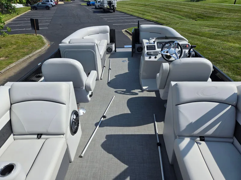 Slide: The Image of 2021 Crest Classic LX 220 SLC pontoon boat interior with plush seating and modern dashboard. - 20