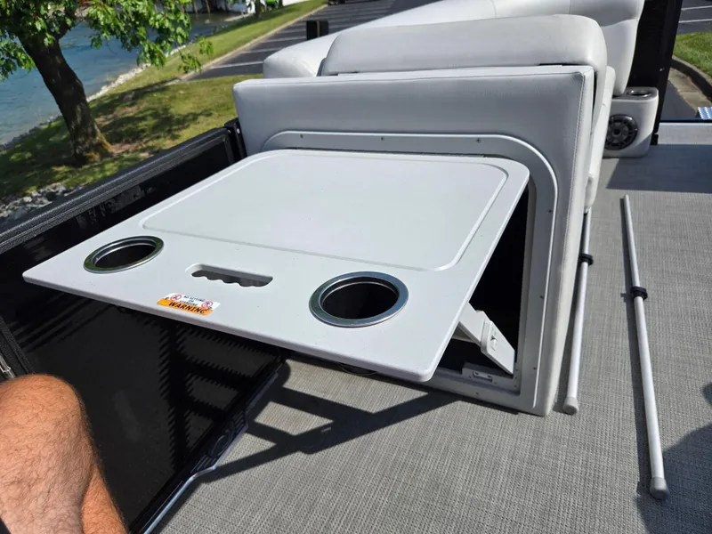 Slide: The Image of 2021 Crest Classic LX 220 SLC boat with foldable table and cup holders. - 23