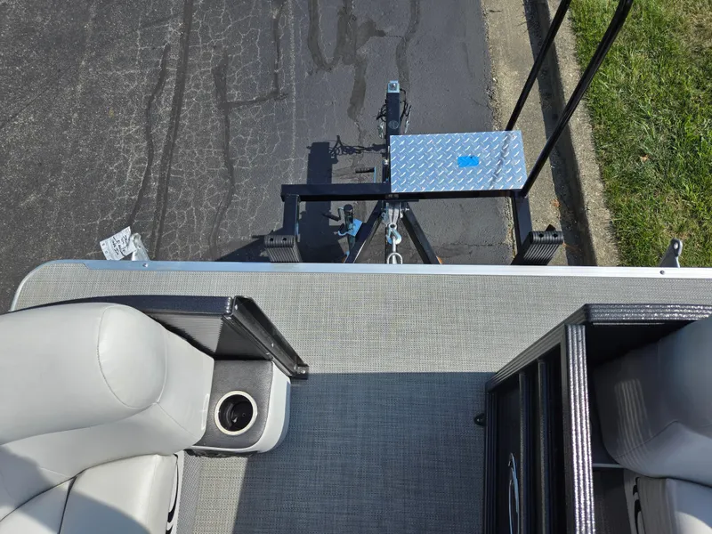 Slide: The Image of 2021 Crest Classic LX 220 SLC boat interior with seating and trailer hitch. - 25