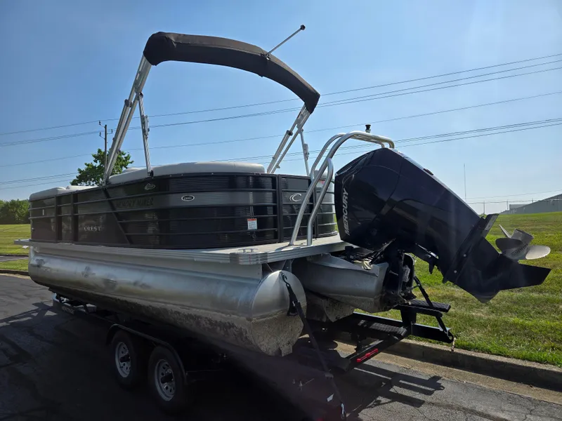 Slide: The Image of 2021 Crest Classic LX 220 SLC pontoon boat on trailer, sunny day. - 3