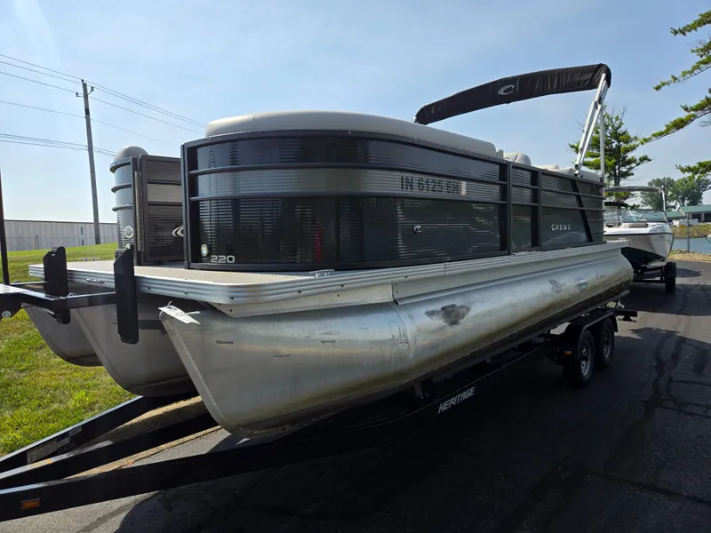 Slide: The Image of 2021 Crest Classic LX 220 SLC pontoon boat on trailer, parked outdoors. - 5