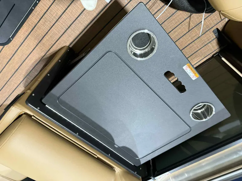 Slide: The Image of 2026 Bentley Pontoons Elite 223 interior with cup holders and sleek design. - 12