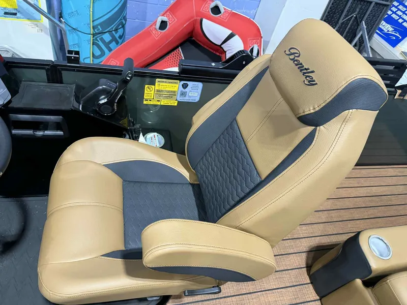 Slide: The Image of 2026 Bentley Pontoons Elite 223 captain's chair with tan and black upholstery. - 15