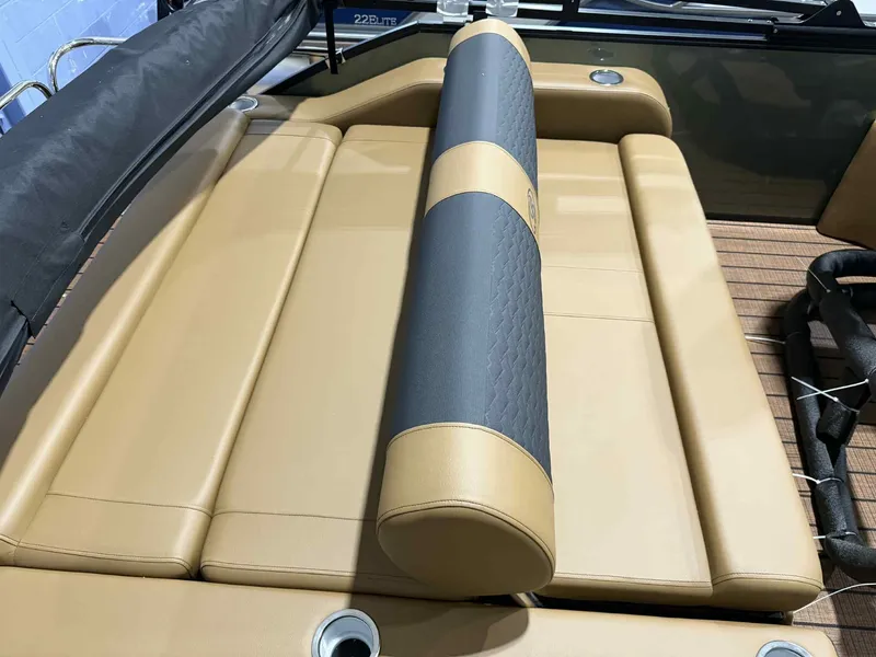 Slide: The Image of 2026 Bentley Pontoons Elite 223 Swingback interior with tan and gray seating. - 17
