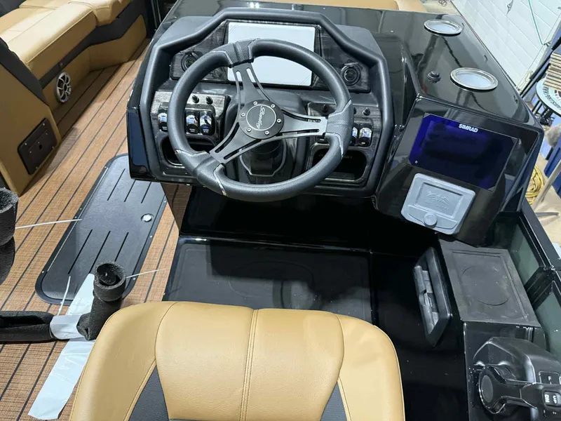 Slide: The Image of 2026 Bentley Pontoons Elite 223 Swingback dashboard with steering wheel and controls. - 18
