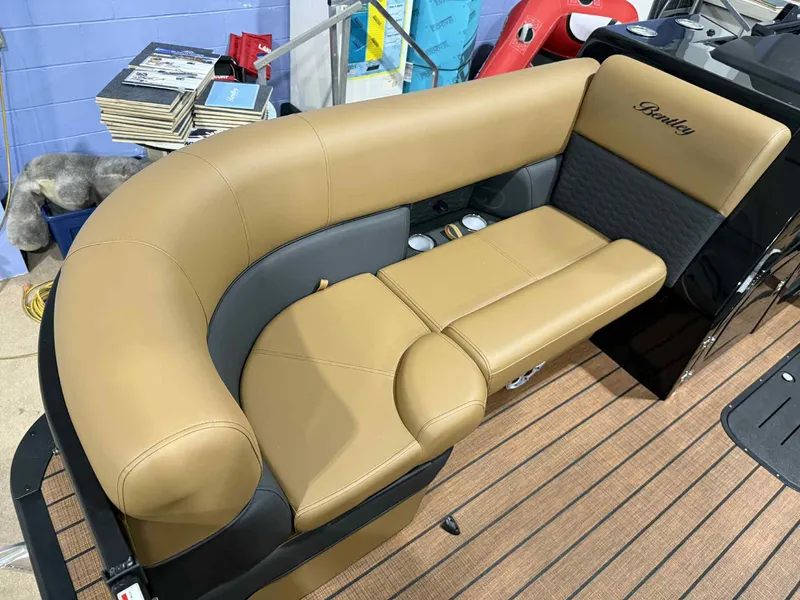 Slide: The Image of 2026 Bentley Pontoons Elite 223 Swingback Dual Captain seating, tan and black upholstery. - 3