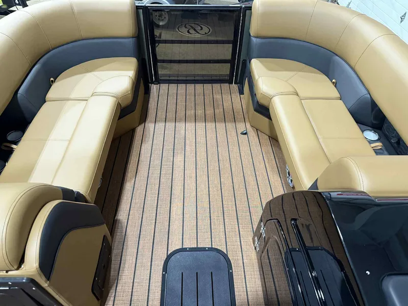 Slide: The Image of 2026 Bentley Pontoons Elite 223 interior with tan seating and wood-style flooring. - 9