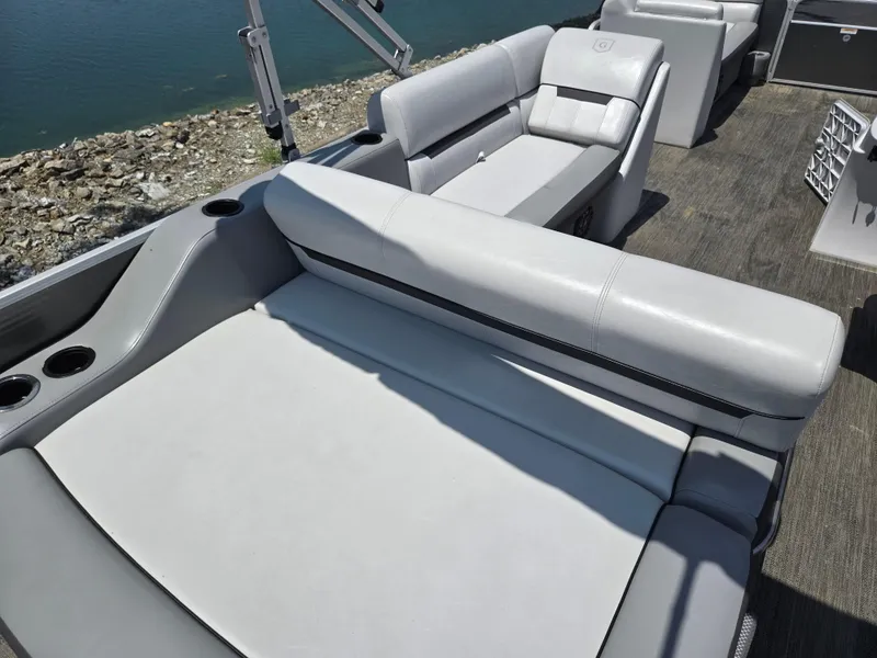 Slide: The Image of 2021 Godfrey SWEETWATER 2286 SFL boat interior with comfortable seating and cup holders. - 16