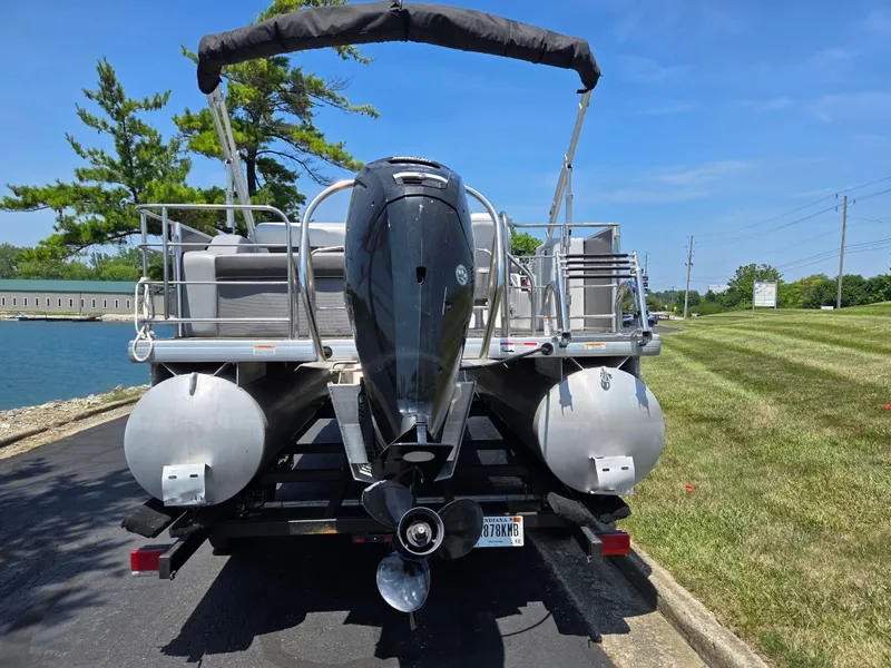 Slide: The Image of 2021 Godfrey SWEETWATER 2286 SFL pontoon boat on trailer, rear view, sunny day. - 2