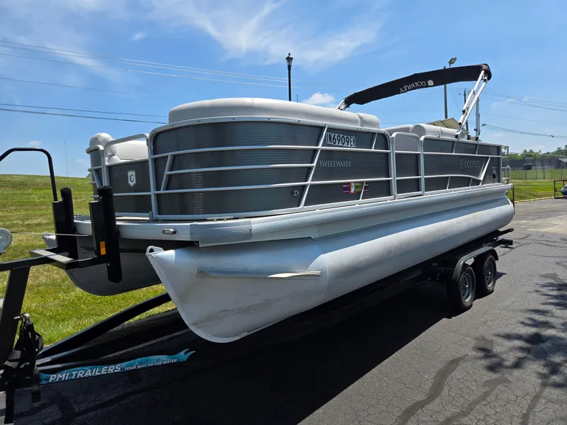 Slide: The Image of 2021 Godfrey SWEETWATER 2286 SFL pontoon boat on trailer, parked outdoors. - 5
