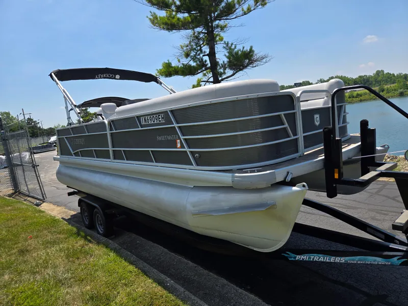 Slide: The Image of 2021 Godfrey SWEETWATER 2286 SFL pontoon boat on trailer by a lake. - 9