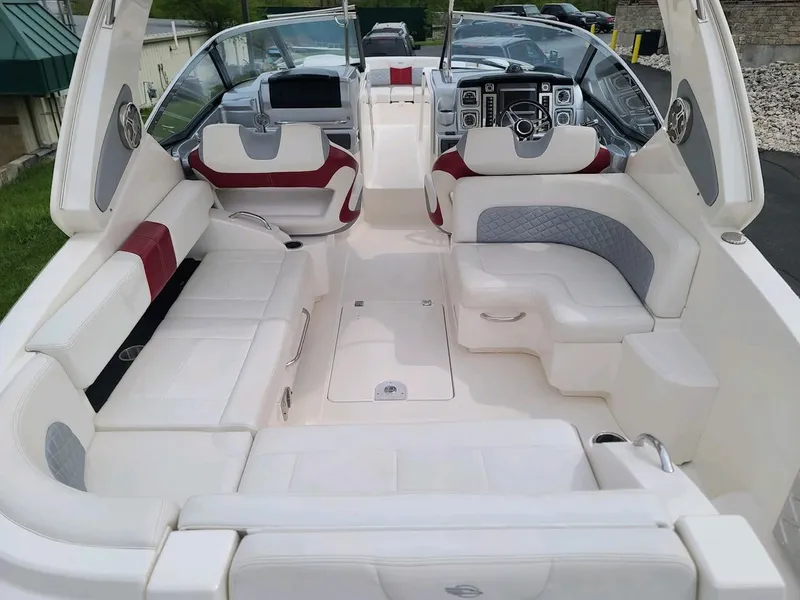 Slide: The Image of 2013 Chaparral 327 SSX boat interior with luxurious white seating and modern dashboard. - 11