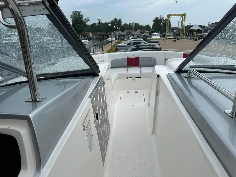 Slide: The Image of 2013 Chaparral 327 SSX boat interior with seating, docked at marina. - 12