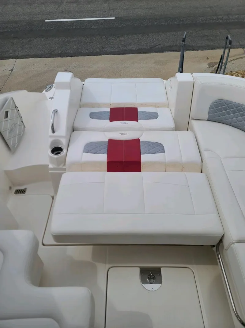 Slide: The Image of 2013 Chaparral 327 SSX boat interior with white and red cushioned seating. - 15