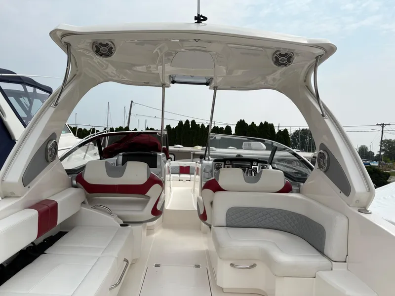 Slide: The Image of 2013 Chaparral 327 SSX boat interior with white and red seating, modern design. - 16