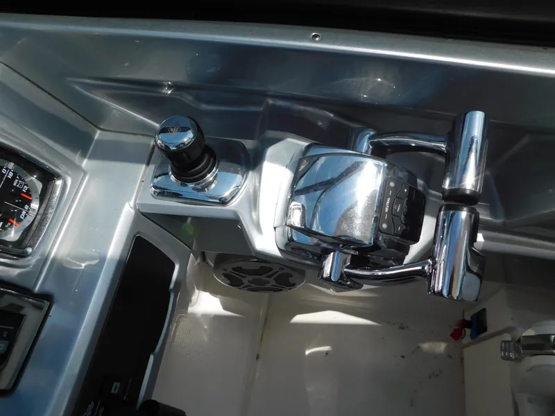 Slide: The Image of Control panel of 2013 Chaparral 327 SSX boat with chrome throttle and joystick. - 19